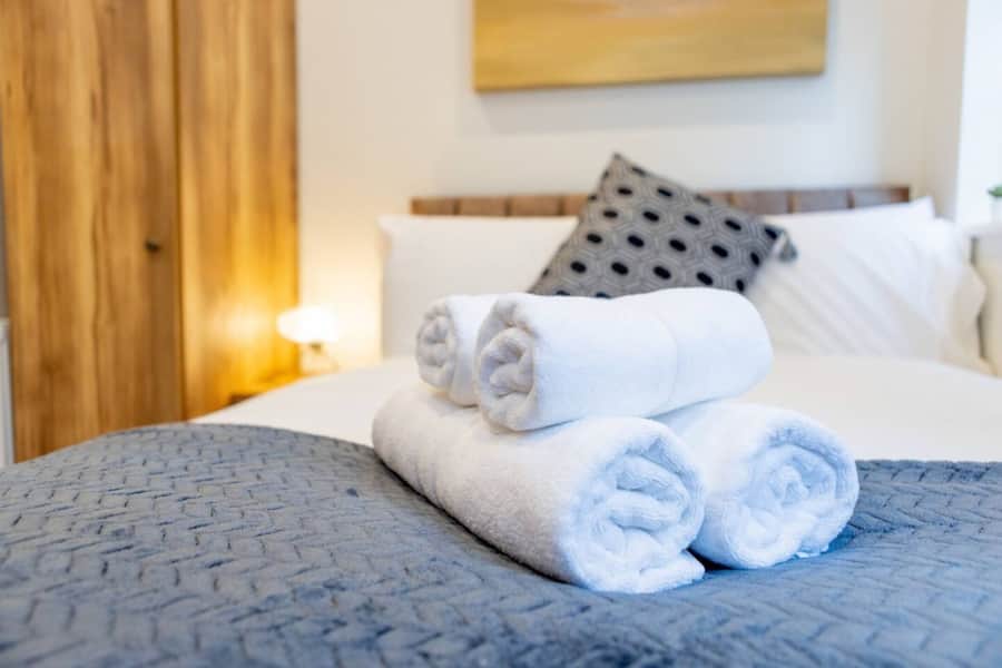 Double bedroom with fresh towels in Apartment 1